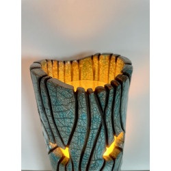 Beautiful raku cracks and a glossy glaze give it its elegance. A unique piece